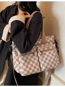 Brown and white checkered corduroy tote bag with front pockets and adjustable strap