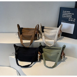 Nylon dumpling bags with wooden bead charms in brown, beige, black, and olive green