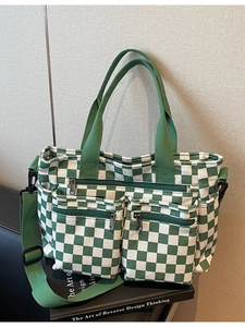Green checkerboard canvas tote bag with adjustable shoulder strap and multi-pocket design