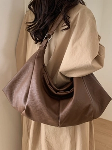 Large dark brown pebbled leather tote bag with soft pleated design and silver rings
