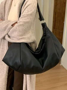 Retro pleated black hobo bag with litchi texture and silver ring on a model