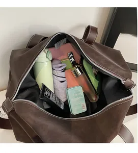Spacious interior of dark brown oversized tote bag holding laptop, umbrella, and daily items