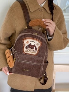 Brown corduroy puppy backpack with toast embroidery and plush bread pendant accessory