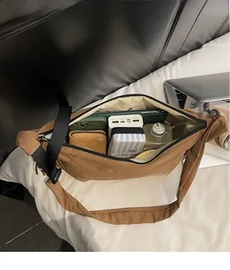 Interior view showing large capacity storage for phone and wallet in brown nylon bag