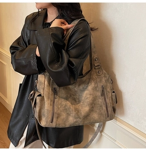 Detail shot of the large vintage tote bag featuring dual side zipper pockets and retro texture