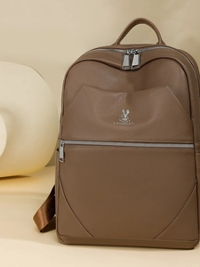 Fashionable dark brown leather backpack with silver zippers and elegant rabbit logo detail
