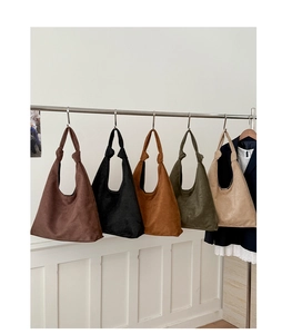 Detailed display of vintage suede tote bags in five colors with unique knotted handles