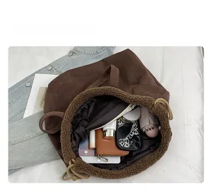 Macro view of a large brown tote bag showing its spacious interior and faux fur trim