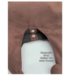 Close-up of secure magnetic snap closure on vintage brown suede tote bag