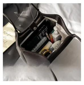 Detail view of large dark brown tote bag with spacious interior and magnetic closure