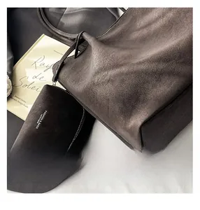Close-up of minimalist suede tote set featuring premium leather texture and branding