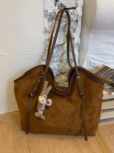 Brown faux suede tote bag with large capacity and cartoon wolf charm for daily use