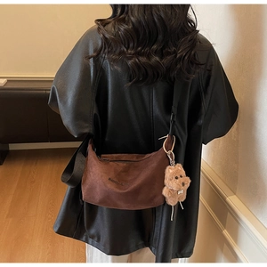 Brown faux suede half-moon crossbody bag with cute teddy bear charm and embroidered text