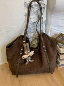 Brown faux suede tote bag with rabbit charm and adjustable strap for women