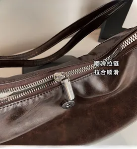 Detail shot of smooth silver metal zipper on the high-capacity dark brown tote bag