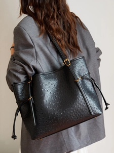 Black ostrich pattern leather tote bag for women with golden hardware and drawstring detail