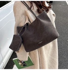 Close-up of retro brown tote bag with white contrast stitching and mini coin purse