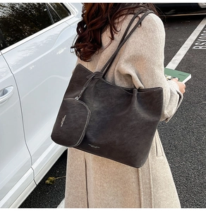 Detail of dark brown matte suede tote bag with small detachable matching charm pouch