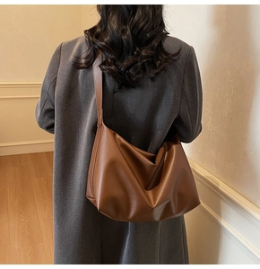 Close-up of caramel PU leather tote bag with soft texture and wide shoulder strap