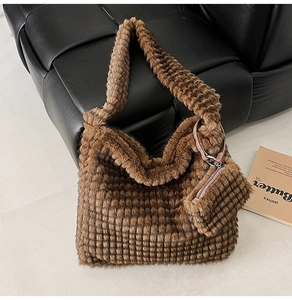 Detailed view of dark brown faux fur tote bag with checkered texture and coin purse