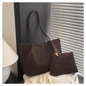Detailed close-up of dark brown suede tote bag and matching pouch with premium matte finish