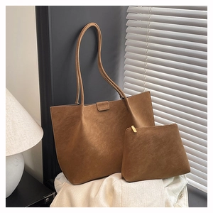 Detail of brown suede tote bag with matching pouch and delicate leather straps