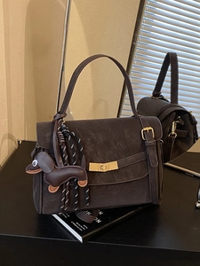 Retro dark brown crossbody square bag with gold twist lock and dachshund charm detail