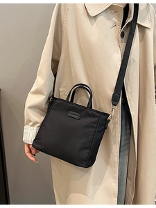 Chic black nylon tote crossbody bag with gold hardware and CLEARING logo for women