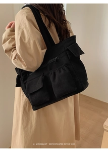 Minimalist black corduroy tote bag detail featuring multiple functional pockets for commuting
