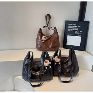Three retro faux leather tote bags in black, chocolate, and caramel brown with alpaca charms