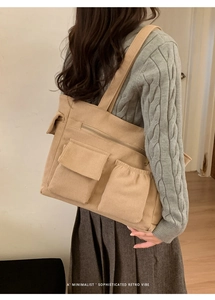 Detail showing high-quality corduroy texture and front pockets on a beige tote bag