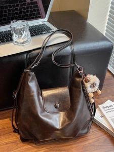 Large dark brown vintage leather hobo bag with a cute plush charm for women
