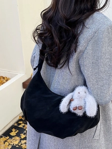 Minimalist black crescent hobo shoulder bag with a white plush bunny pendant