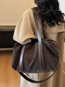 Deep brown large travel tote bag with matte texture and white contrast stitching details