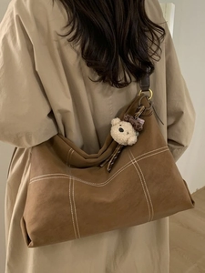 Brown frosted leather oversized hobo bag with contrast stitching and bear charm