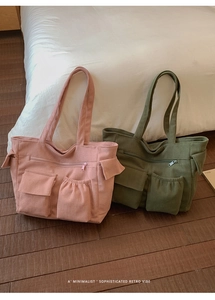 Pink and army green corduroy tote bags with pockets on a minimalist indoor floor