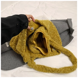 Detail showing ginger plush tote bag with internal zipper pocket and magnetic snap closure