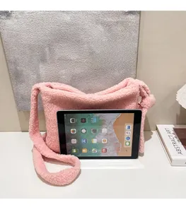 Pink plush tote bag size comparison with tablet showing its large storage capacity