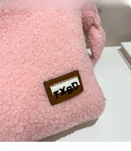 Macro shot of pink fuzzy faux fur texture with a rectangular TXBD fabric patch detail