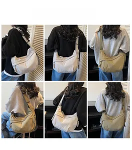 Detail view of stylish half-moon crossbody bags in light grey and olive green colors