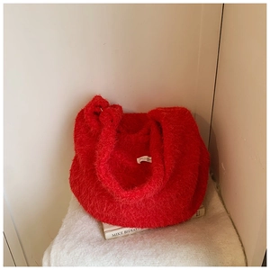 Macro shot of red faux fur shoulder bag texture and large capacity interior view