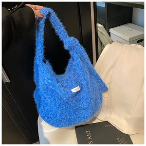 Detail of Klein blue knit tote bag showing soft plush texture and minimalist label