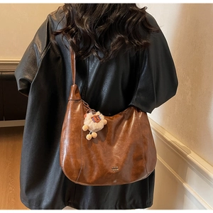 Brown vintage hobo tote bag with soft texture and cute white plush sheep charm