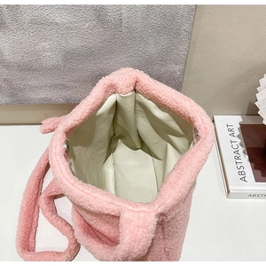 Close-up of pink plush tote bag interior featuring secure silver magnetic snap closure