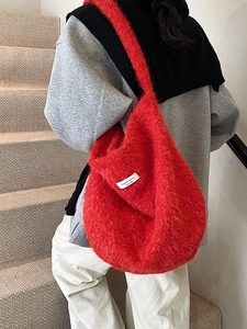 Large red fuzzy wool shoulder bag with a branded label in a casual commute style