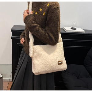 Detailed macro view of white fluffy faux fur crossbody bag with soft plush texture