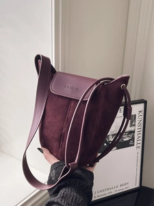 Burgundy suede and smooth leather bucket bag with slim shoulder strap and logo