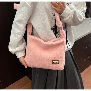 Detailed close-up of pink faux fur shoulder bag with soft plush texture and leather logo