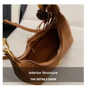 Detail view of the brown matte shoulder bag interior with secure zipper pocket