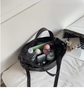 Large capacity tote bag interior view showing space for umbrella, bottle, and wallet